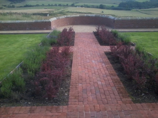 Cottage Style Symmetrical Brick Path leading to Belvedere with Block Planting to either side