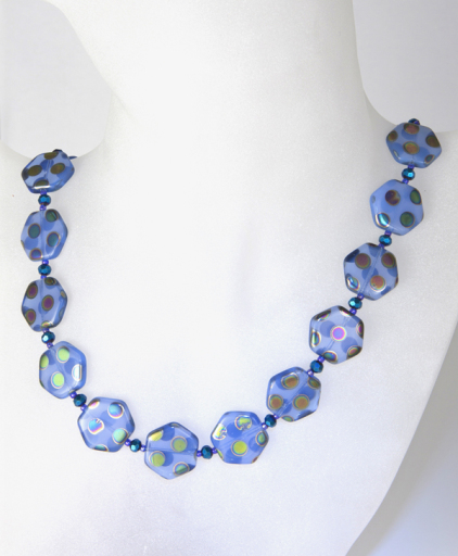 A stunning necklace made with glass beads with splashes of peacock colour and crystals.