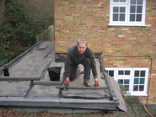 Richard Crow - Reliable Roofing owner laying a new flat roof.