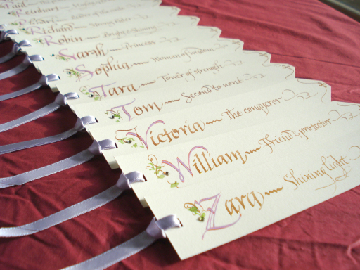 Place cards in book mark style have been written in the colour of the bride's bouquet