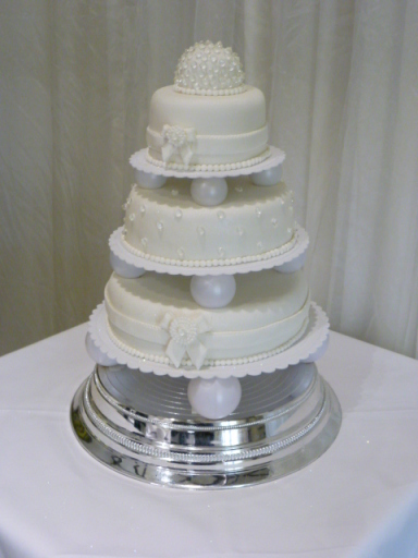 3-tier sponge wedding cake with edible diamonds, sugar bows and brooch