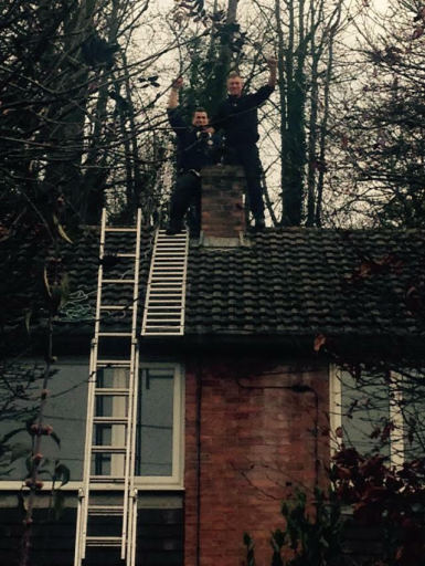 Father and son completing chimney repairs