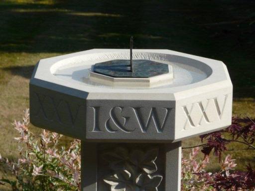 Sundial stand and birdbath with carved lettering