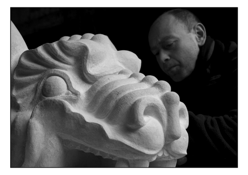 Tutor Pete Graham carving a dragon head