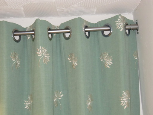 LINED &amp; INTERLINED EYELET CURTAINS INSIDE THE RECESS OF A DOOR.