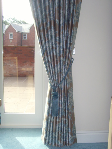 Curtains with decorative tassle tie-back