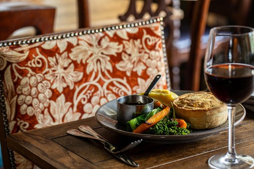 Handmade chicken & ham hock pie served with mash and buttered vegetables.