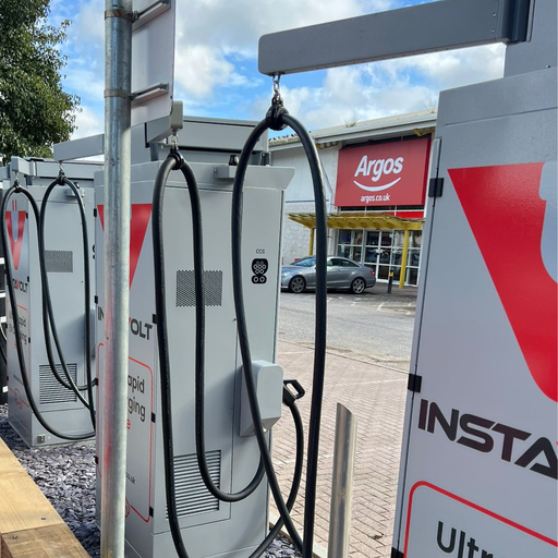 Detailed view of an InstaVolt charger with visible CCS connector, situated near an Argos store. Highlighting convenient retail access for EV drivers while charging.