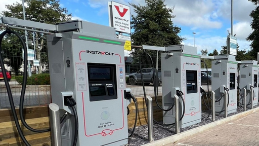 A row of InstaVolt ultra-rapid chargers located in a clean, tree-lined car park on Plymouth Road in Liskeard, with multiple bays available for EV drivers.