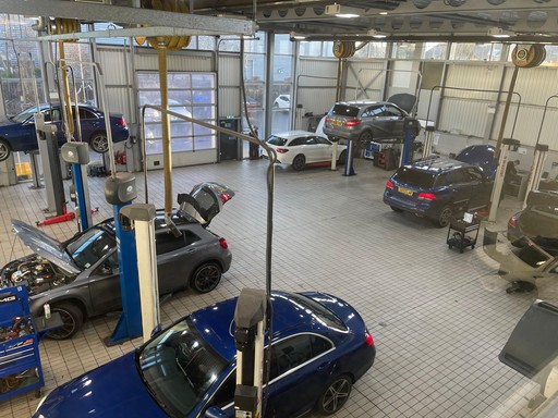 Cars inside the Mercedes Ben of Ayr service centre workshop