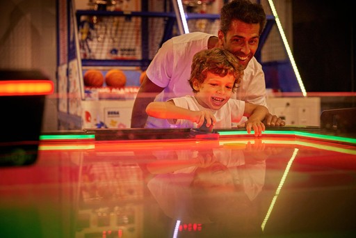 Family playing in the arcade at Hunters Quay Holiday Village