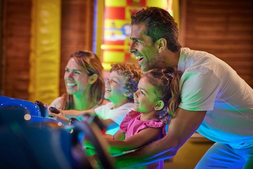 Family playing in the arcade at Hunters Quay Holiday Village