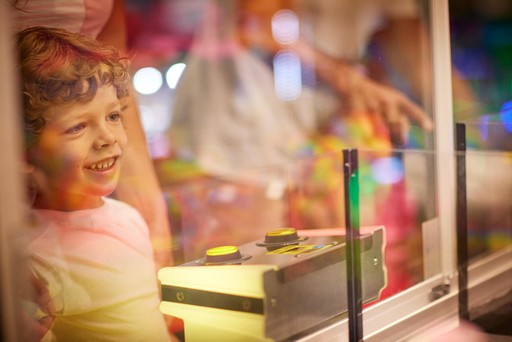 Family playing in the arcade at Hunters Quay Holiday Village