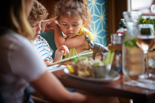 Family enjoy a meal in Hunters Bar and Grill at Hunters Quay Holiday Village
