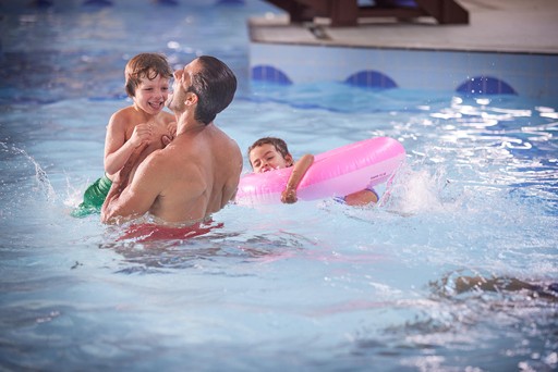 Family have fun playing in the swimming pool at Hunters Quay Holiday Village