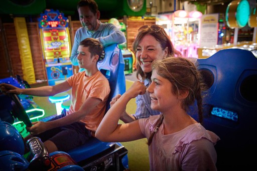 Family playing in the arcade at Hunters Quay Holiday Village