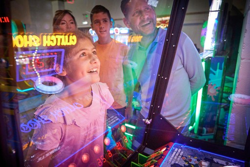 Family playing in the arcade at Hunters Quay Holiday Village