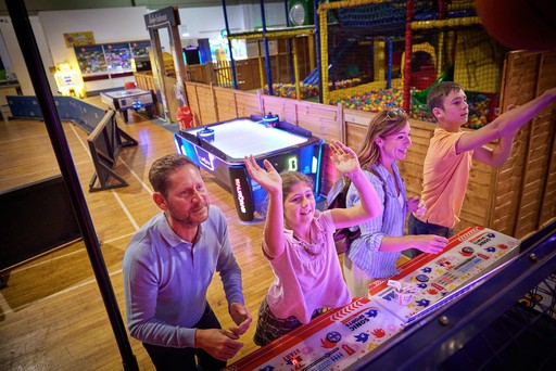 Family playing in the arcade at Hunters Quay Holiday Village