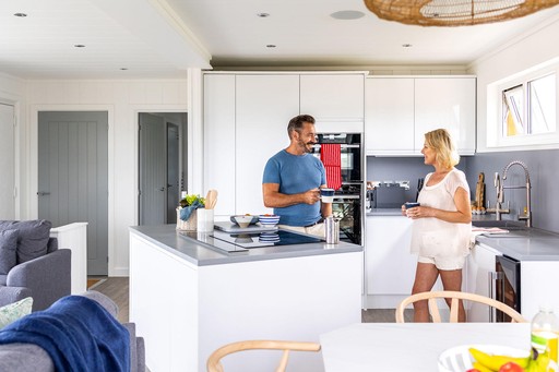 Couple in the kitchen area of their Luxury Eco Lodge at Gwel an Mor