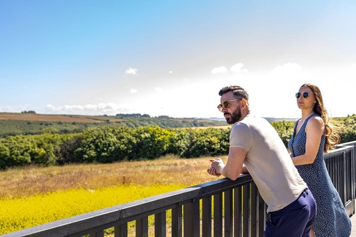 Couple admire the view from their lodge at Gwel an Mor