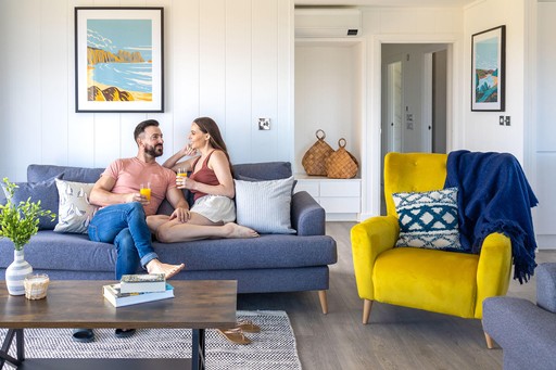 Couple relax in the living area of one of our lodges at Gwel an Mor