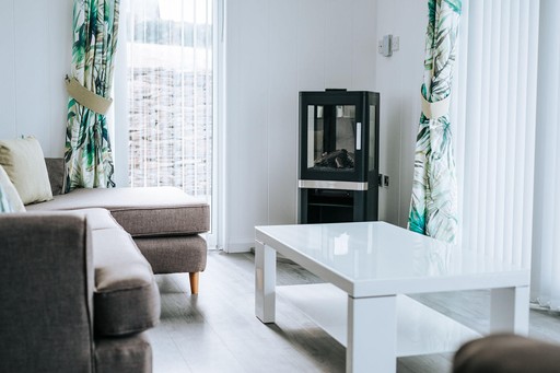 Living area with view of wood burning stove in one of our Luxury Eco Lodges at Gwel an Mor