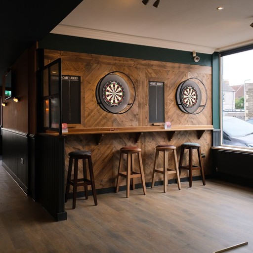 Dedicated darts zone with dual boards and scoreboards, ideal for friendly competition and social play.