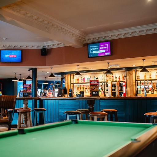 Open bar area with pool table and multiple screens, creating a lively space for games, drinks and live sport.