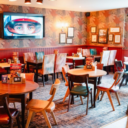 Stylish dining area with patterned walls and comfortable seating, ideal for enjoying meals in a relaxed setting.
