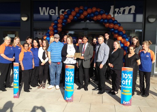 B&M staff at the new Kingsmead store in Stafford present special guests Headway South Staffordshire with £250 worth of B&M vouchers.