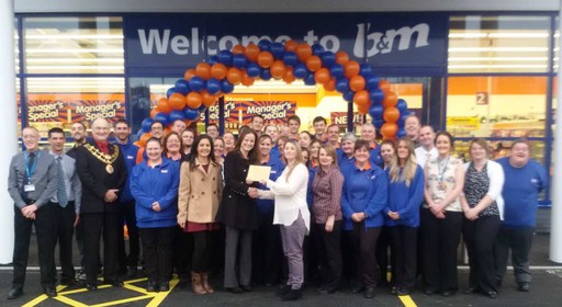 A representative from local charity, the Little Wrens, gratefully receiving £250 worth of B&M vouchers on B&M Bodmin's opening day.