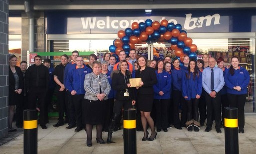 B&M Inshes's Local Hero, The Archie Foundation, gratefully receiving £250 worth of B&M vouchers as a thank you for opening the store.