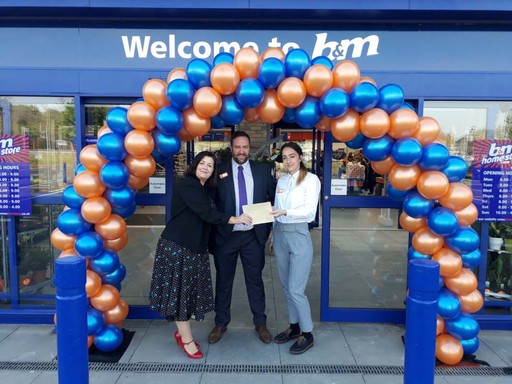 B&M Goldington's store manager welcomes local charity Faces on opening day. The charity received £250 worth of B&M vouchers as a thank you for taking part in B&M's special day,