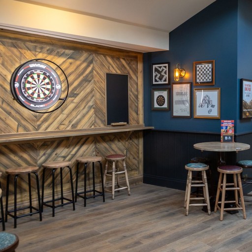Dedicated darts zone with dual boards and scoreboards, ideal for friendly competition and social play.