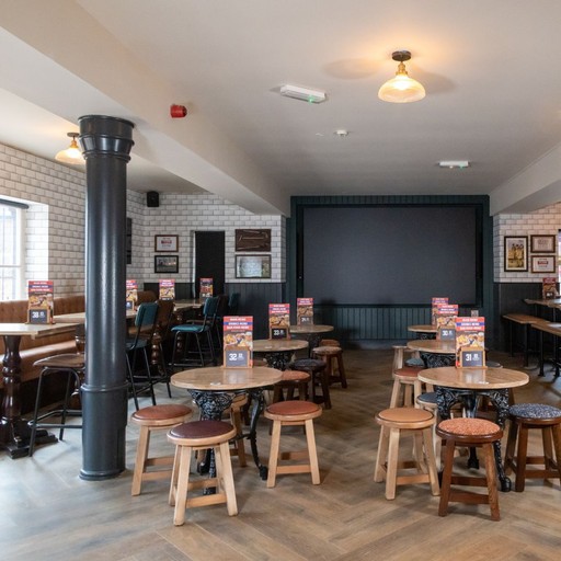 Dedicated sports viewing area with multiple screens and flexible seating, perfect for watching live matches.