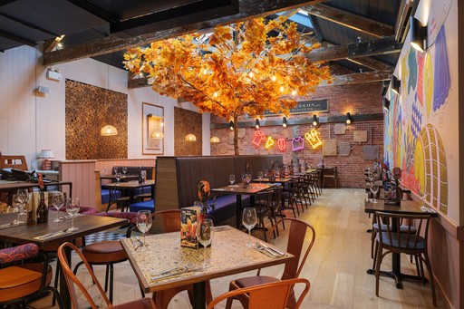 Warm Zizzi Winchester interior with vibrant décor and open kitchen.