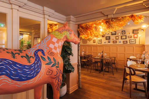 Warm Zizzi Winchester interior with vibrant décor and a painted horse.