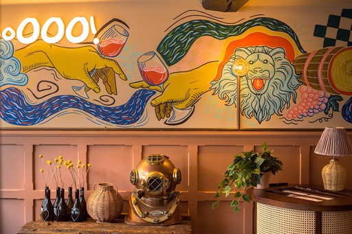 Warm Zizzi Winchester interior with vibrant décor and art murals on wall.