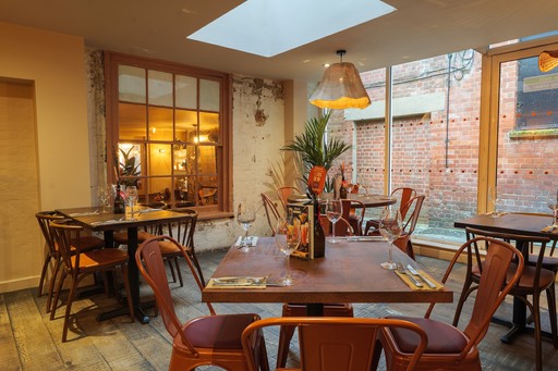 Warm Zizzi Winchester interior with cosy booths and view outside.