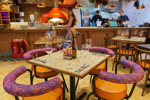 Warm Zizzi Winchester interior with vibrant décor and open kitchen.