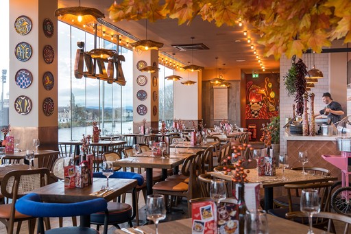 Zizzi Inverness, open-plan dining with full-height windows overlooking the River Ness.