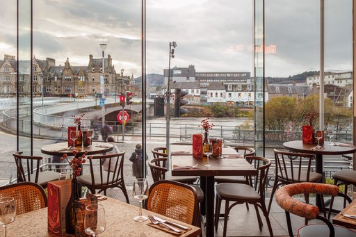 Zizzi Inverness, open-plan dining with full-height windows overlooking the River Ness.