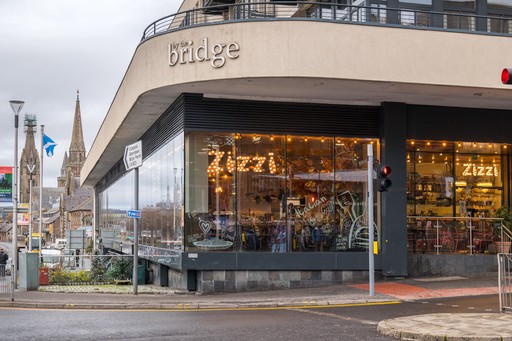 Zizzi Inverness, open-plan dining with full-height windows overlooking the River Ness.