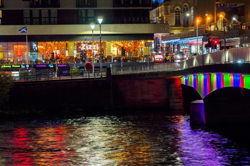 Zizzi Inverness at night, open-plan dining with full-height windows overlooking the River Ness.