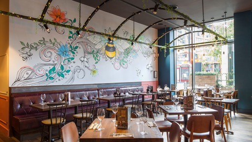 Stylish dining area at Zizzi Manchester Piccadilly with modern decor and natural accents.