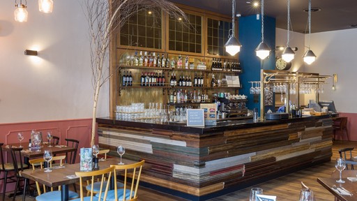 Stylish dining area at Zizzi Manchester Piccadilly with modern decor and natural accents.