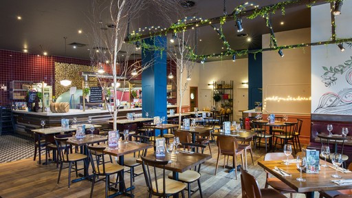 Stylish dining area at Zizzi Manchester Piccadilly with modern decor and natural accents.