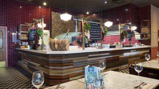Stylish dining area at Zizzi Manchester Piccadilly with modern decor and natural accents.