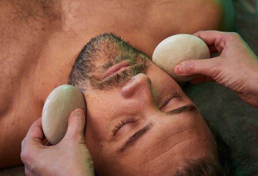 A person experiencing the Highlands full body hot stone massage spa treatment.