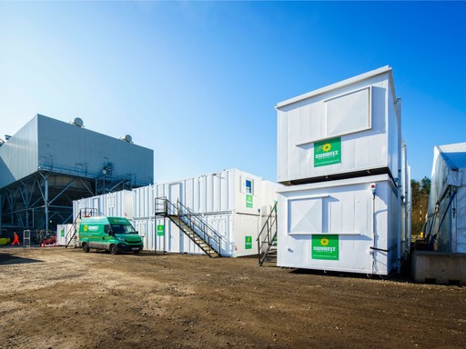 Sunbelt Rentals branded welfare cabins on-site with a green delivery van parked nearby.